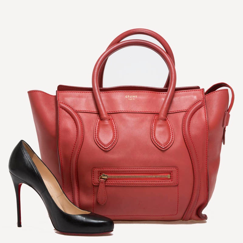 This enticing Celine Smooth Leather Luggage in size Mini is constructed in beautiful smooth dusty red leather, and gold-tone hardware. The sturdy rolled handles, detailed stitching and front zipper pockets compliment the bag's classic design. The