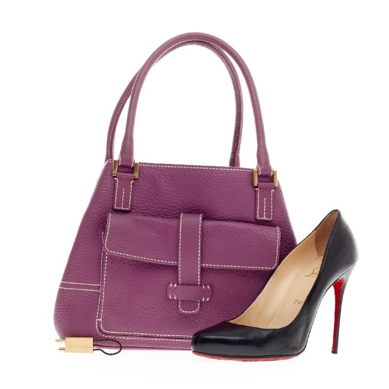 This authentic Loro Piana Globe Tote Leather Mini is a versatile everyday bag. Constructed from vivid eye-catching purple leather, this bag features white contrast stitching, oversized exterior frontal flap pocket, and exterior back zipped pocket