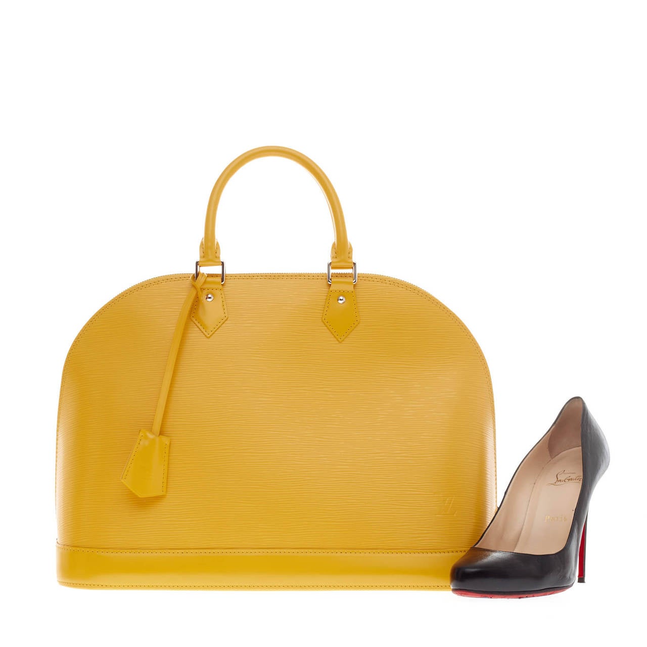 This authentic Louis Vuitton Alma Epi Leather GM is an elegant and practical handbag perfect for fashionistas with its classic shape and a very roomy interior. Crafted in a striking citron yellow epi leather, this structured dome bag features dual