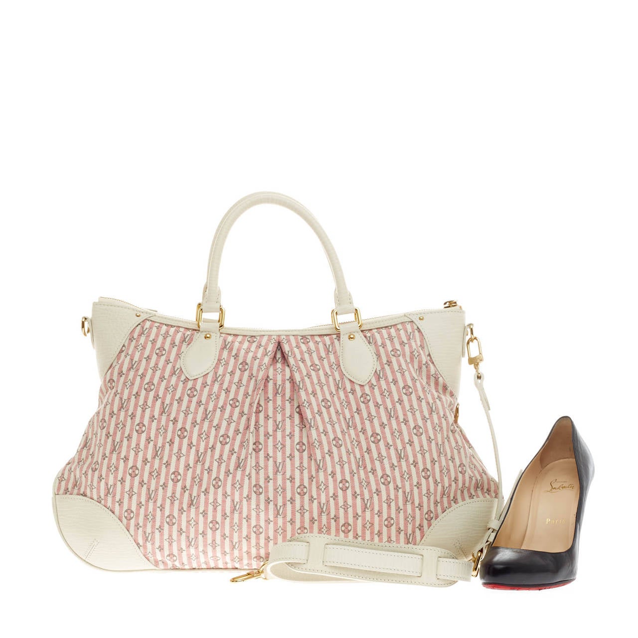 This authentic Louis Vuitton Marina Mini Lin Croisette GM in perfect for the on-the-go fashionista. Crafted from pink striped mini lin monogram canvas with white leather trims, this feminine pleated satchel features dual-rolled handles and gold-tone