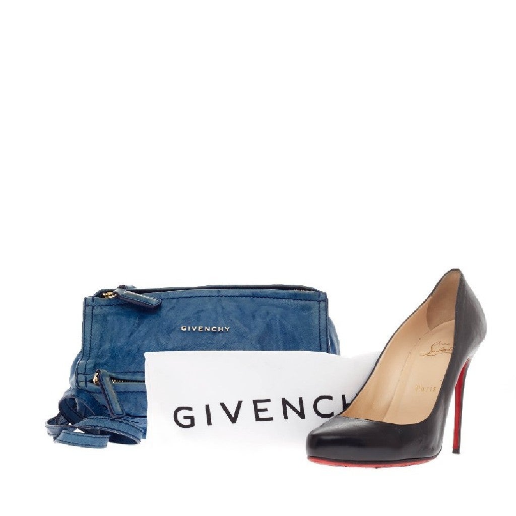 This authentic Givenchy Pandora Bag Leather Mini is an easy to carry, everyday handbag that is both stylish and functional. Constructed in rich blue textured leather with dark blue stitching, this mini version of Givenchy's popular pandora bag