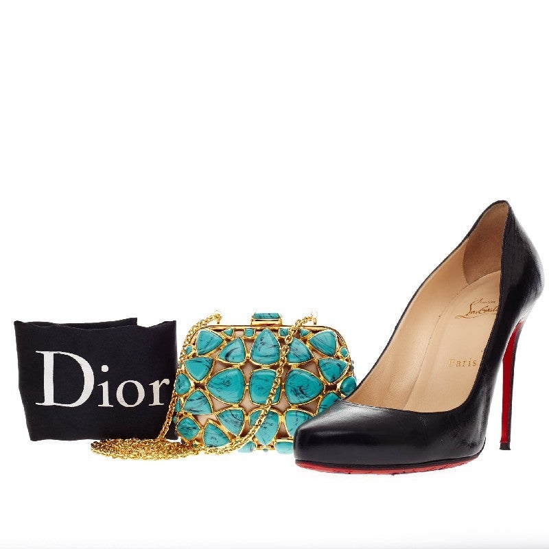 This authentic Christian Dior Minaudiere Turquoise Stones is a luxurious minaudière to take on a night out. This eye-catching metal-framed clutch is embellished in oversized turquoise stones with a brush-stroke effect and a long delicate chain