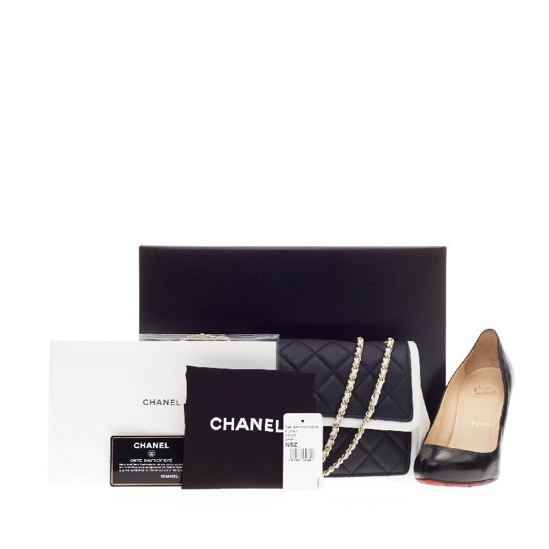 This authentic Chanel Graphic Flap Quilted Calfskin Medium debuting in the brand's Spring/Summer 2013 Collection is a timeless style perfect for day to evening wear. Crafted in black quilted calfskin leather with white contrasting trimming, this