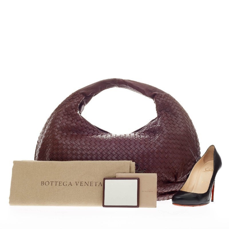 This authentic Bottega Veneta Belly Hobo Intrecciato Nappa Maxi is a timelessly elegant bag with a casual silhouette. Constructed from rich dark purple nappa leather woven in Bottega Veneta's signature intrecciato method, this functional everyday