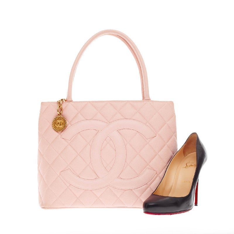 This authentic Chanel Medallion Tote Caviar is an iconic tote in a versatile sleek style that will compliment a multitude of looks. Crafted from in elegant light pink caviar with diamond quilt stitching, this tote features a zip closure, oversized
