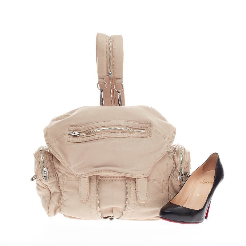 This authentic Alexander Wang Marti Backpack Leather Large is perfect for on-the-go fashionistas. Crafted in ivory beige lambskin leather, this versatile, utilitarian backpack features a vertical zipped center that expands the bag, exterior double
