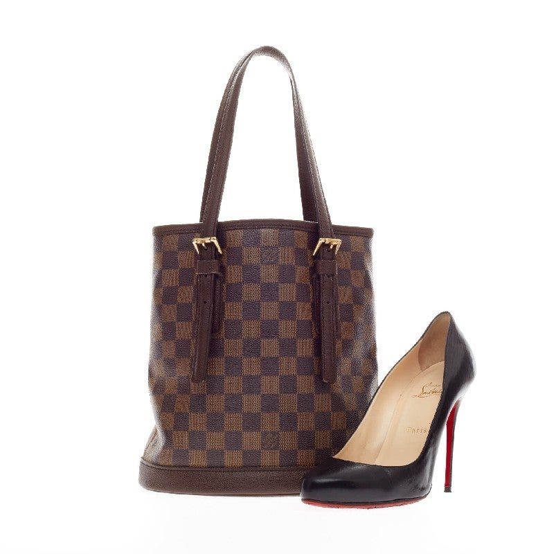 This authentic Louis Vuitton Marais Bucket Damier is easy to transform from season to season. The simple and chic damier ebene canvas bucket bag is constructed with adjustable shoulder straps and a sturdy base with a wide top opening for easy