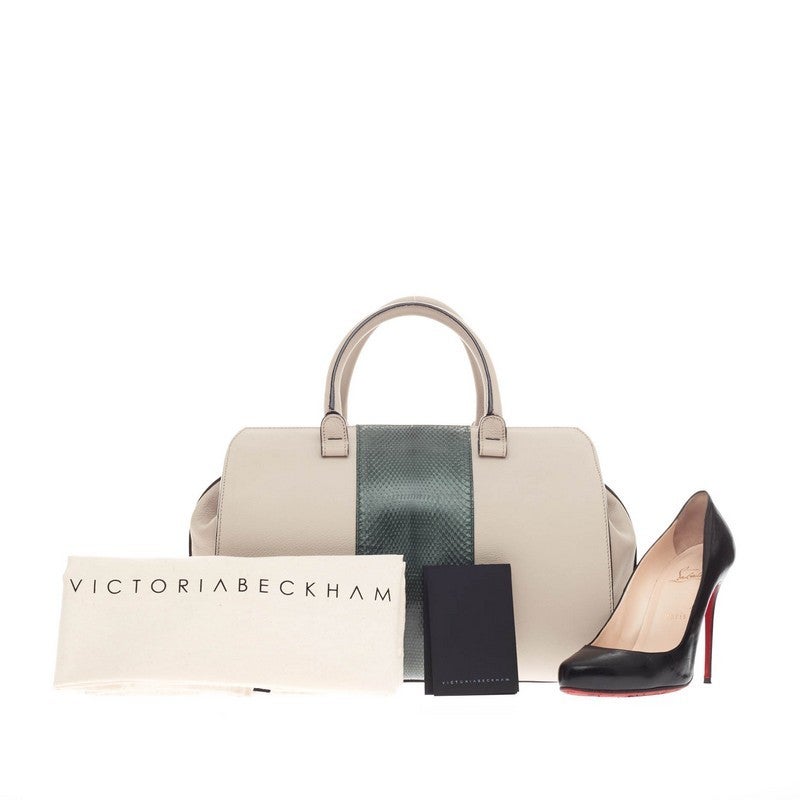 This authentic Victoria Beckham Soft Victoria Tote Leather and Watersnake presented during the designer's Fall/Winter 2012 Runway Collection is simple yet eye-catching everyday bag. Crafted in ivory buffalo moonstone leather and forest green
