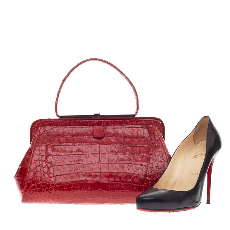 This authentic Nancy Gonzalez Top Handle Frame Bag Crocodile is luxuriously elegant and perfect for an evening out. Known for its highly-crafted exotics, this eye-catching frame bag is meticulously crafted in magnificent red genuine crocodile skin