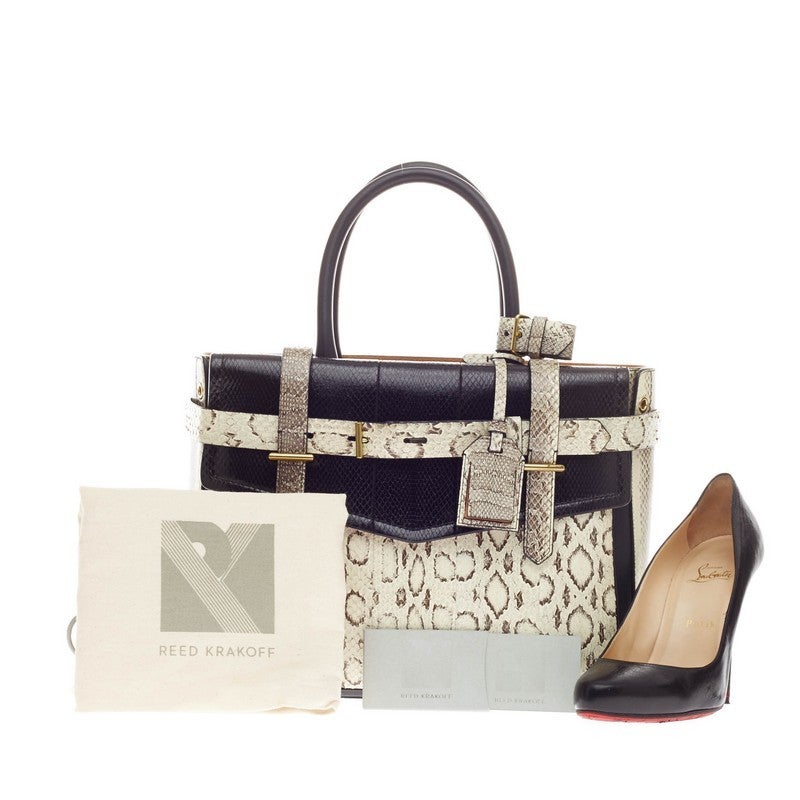 This authentic Reed Krakoff Boxer Tote Viper & Ayers is a versatile and daring structured bag made for the modern woman. Constructed in various, luxurious black and white genuine snake skin, this functional tote features wrap-around leather buckle