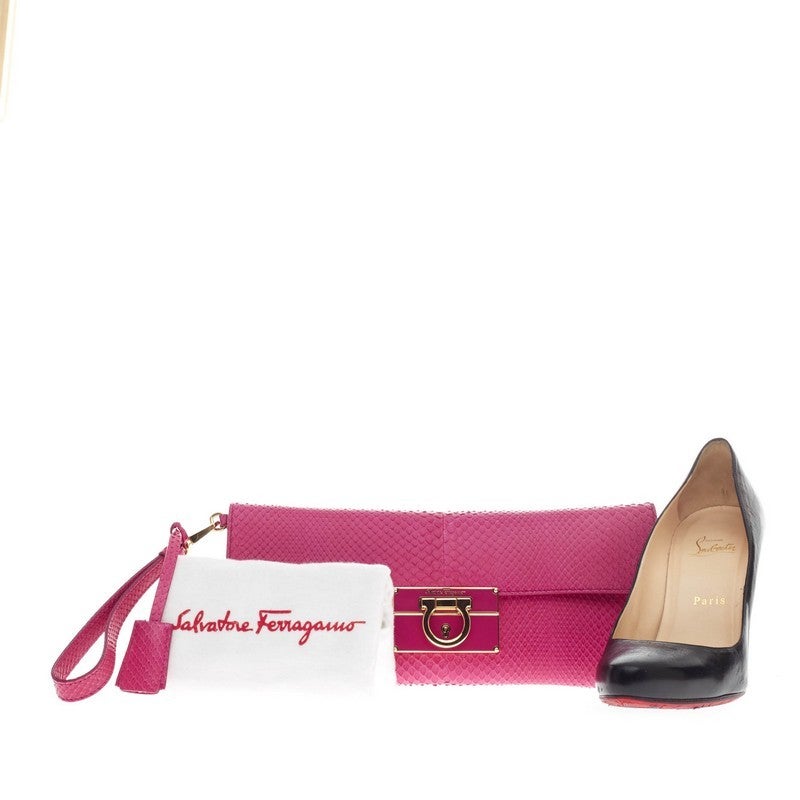 This authentic Salvatore Ferragamo Afef Clutch Python from the brand's 2013 Collection showcases a youthful yet luxurious style perfect for night outs and special occasions. Crafted in vivid hot pink genuine python skin, this elongated flat clutch