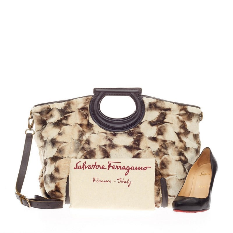 This authentic Salvatore Ferragamo Fiammetta Tote Mink is exquisite in its structure and design. Crafted in plush white brush-dyed genuine mink with dark brown leather trimmings, this luxurious bag features the brand's signature Gancini-styled top