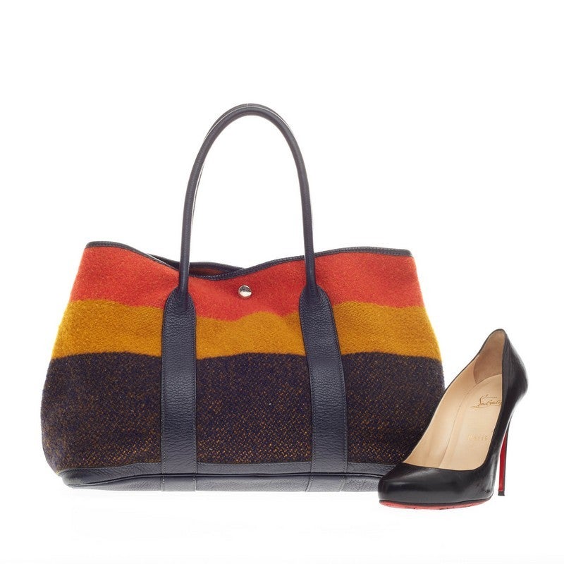 This authentic Hermes Garden Party Tote Rocabar and Leather MM inspired by the brand's classic Rocabar pattern is a unique piece for any Hermes lovers. Crafted in soft wool striped shades of orange, gold and navy with indigo fjord leather trimmings,