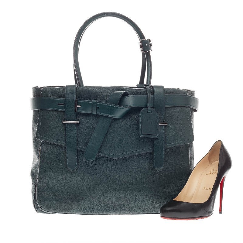 This authentic Reed Krakoff Boxer Tote Leather Medium is a versatile, functional bag that complements both dressy and casual looks perfect for the modern woman. Constructed in dark teal pebbled leather, this no-fuss tote version features wrap-around
