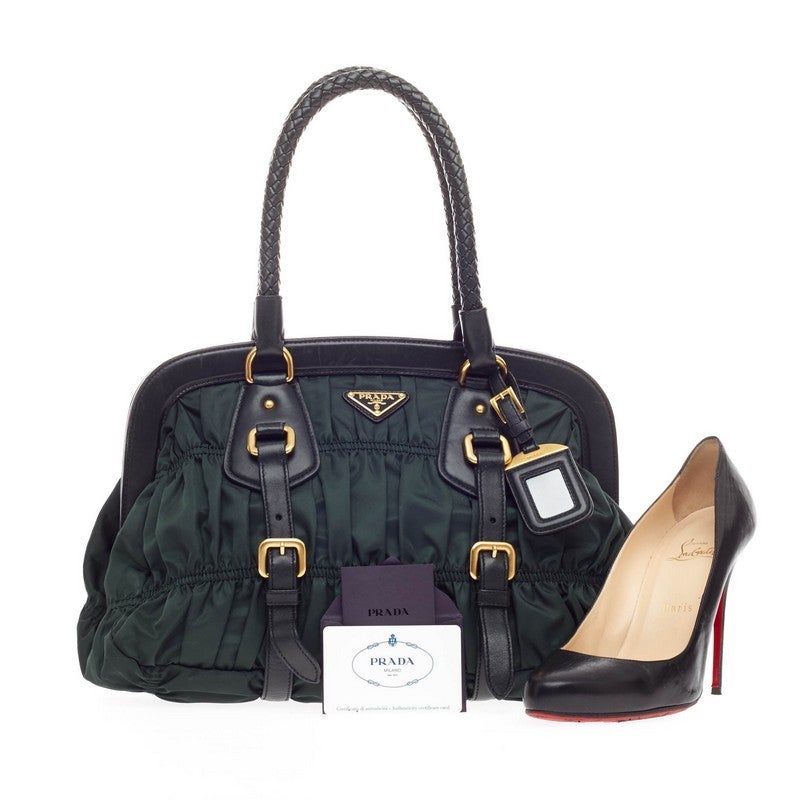 This authentic Prada Gaufre Frame Bag Tessuto is beautifully and intricately crafted in three tiers of gathered dark green tessuto nylon and adorned with gold tone hardware-accent and black leather details. This frame bag features dual-rolled woven