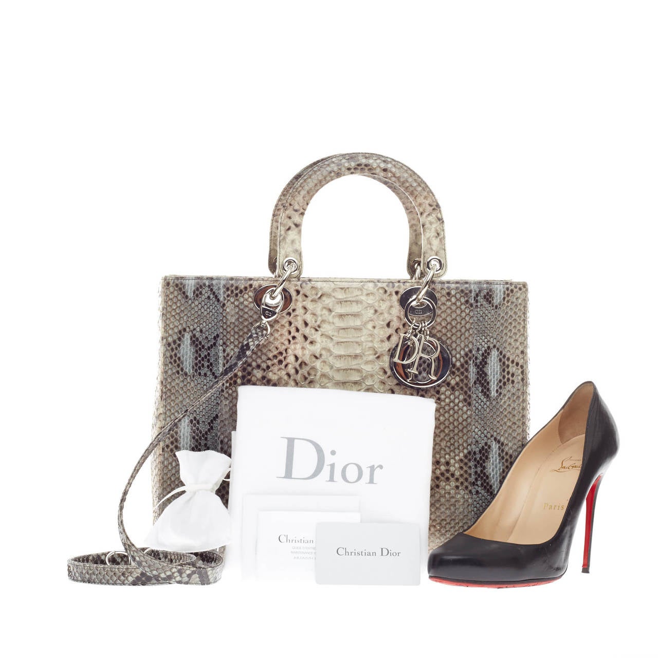 This authentic limited edition Christian Dior Lady Dior Python Large is an elegant and eye-catching piece made for the most daring of fashionistas. Crafted in genuine natural python skin in shaded blue and gray python with hints of pink, this boxy,