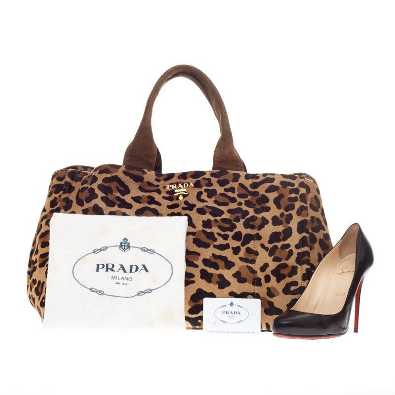 This authentic Prada Tote Cavallino Calf Hair is daring yet sophisticated in design. Crafted from luxurious fine calf hair in an eye-catching leopard print, this tote features dual-top handles, protective base studs, side snap buttons for expansion,