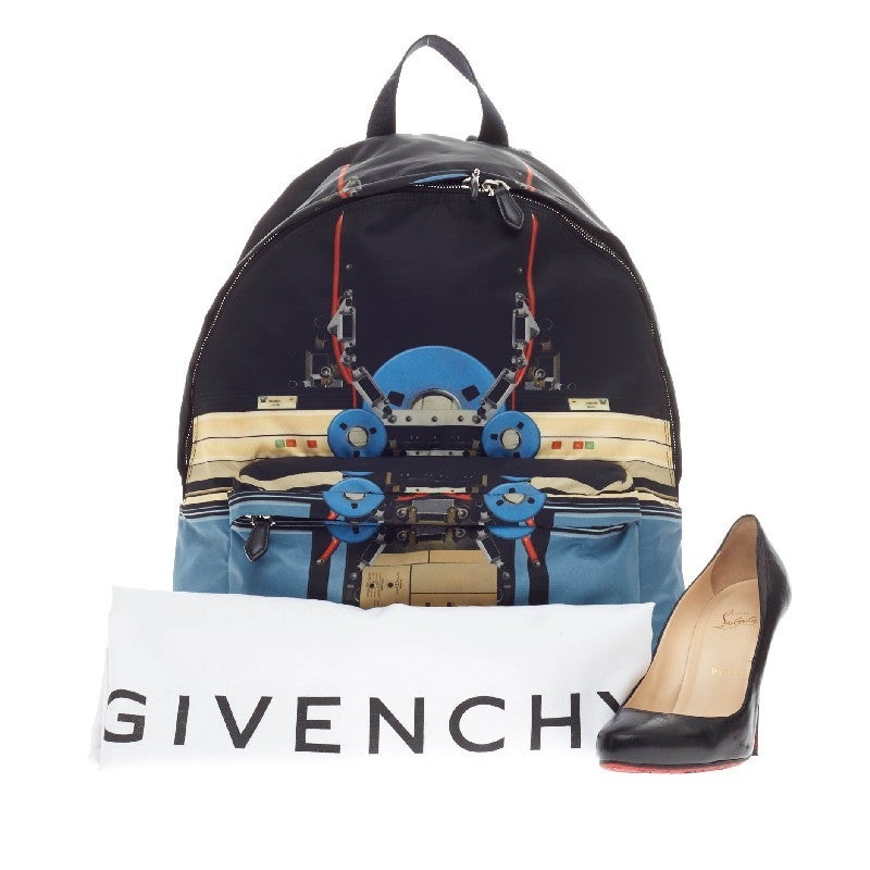 This authentic Givenchy Abstract Backpack Robot Print Canvas from the brand's Fall 2013 Collection is the perfect mix of funky fashion with everyday functionality. Constructed in sturdy black canvas, this eye-catching backpack features a retro