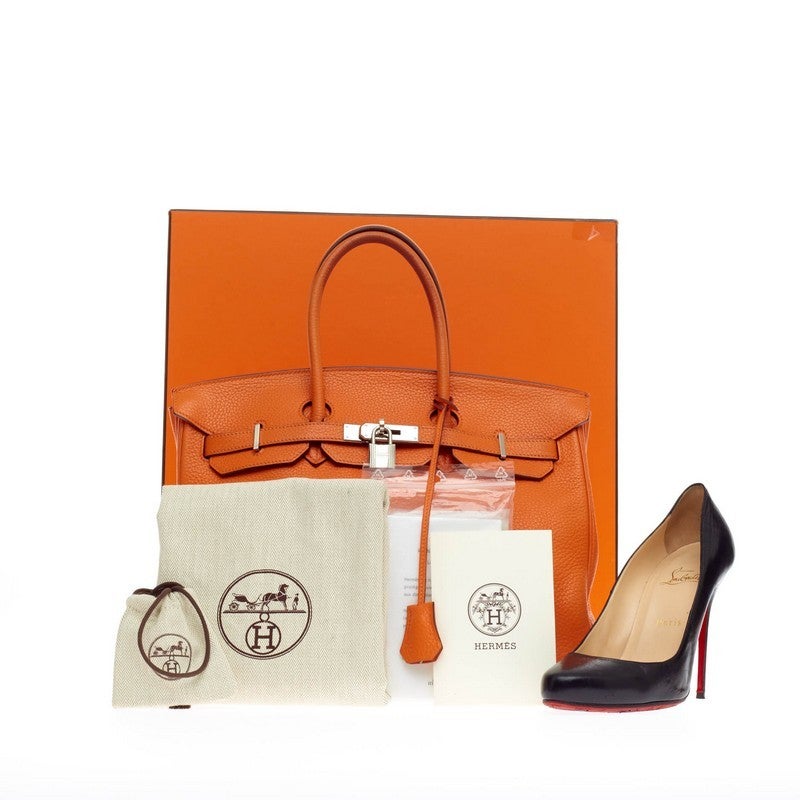 This authentic Hermes Birkin Orange Clemence with Palladium Hardware 35 is the quintessential dream bag for the modern woman. Crafted in iconic and scratch-resistant orange clemence leather, this luxurious tote features dual-rolled top handles,