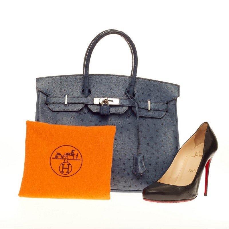 This authentic Hermes Birkin Bleu Roi Ostrich with Palladium Hardware 35 stands as one of the most-coveted bags. Constructed in sumptuous genuine bleu roi ostrich skin, this stand-out tote features dual-rolled top handles, frontal flap, polished