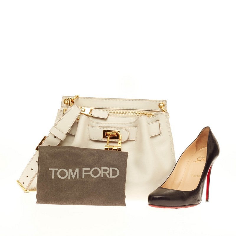 This authentic Tom Ford Lock Front Crossbody Leather presented in the brand's 2014 Collection is both stylish and functional true to Tom Ford's aesthetic. Crafted in sleek white calfskin leather, this alluring crossbody bag features a thick belted