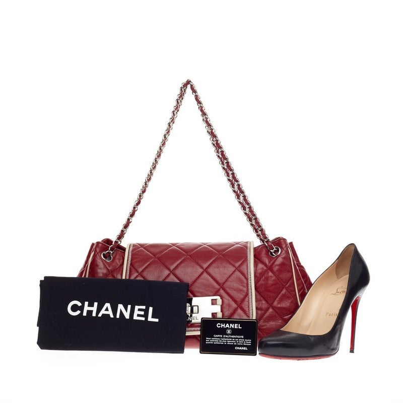 This authentic Chanel East West Accordion Flap Quilted Leather Medium is a classic design perfect for everyday use. Crafted from luxurious red diamond quilted lambskin with beige leather trims, this sophisticated flap bag features Chanel's signature