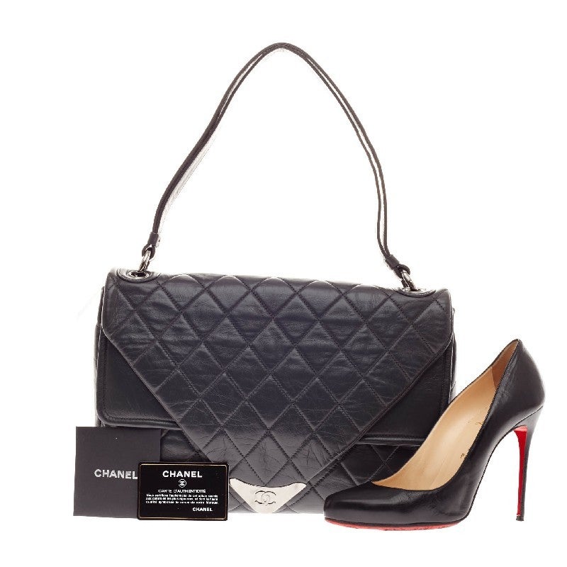This authentic Chanel Padded Envelope Flap Quilted Leather in black showcases an oversized flap design with CC logo plate in soft quilted leather classic to Chanel's design. This oversized shoulder bag features two main double flap compartments,