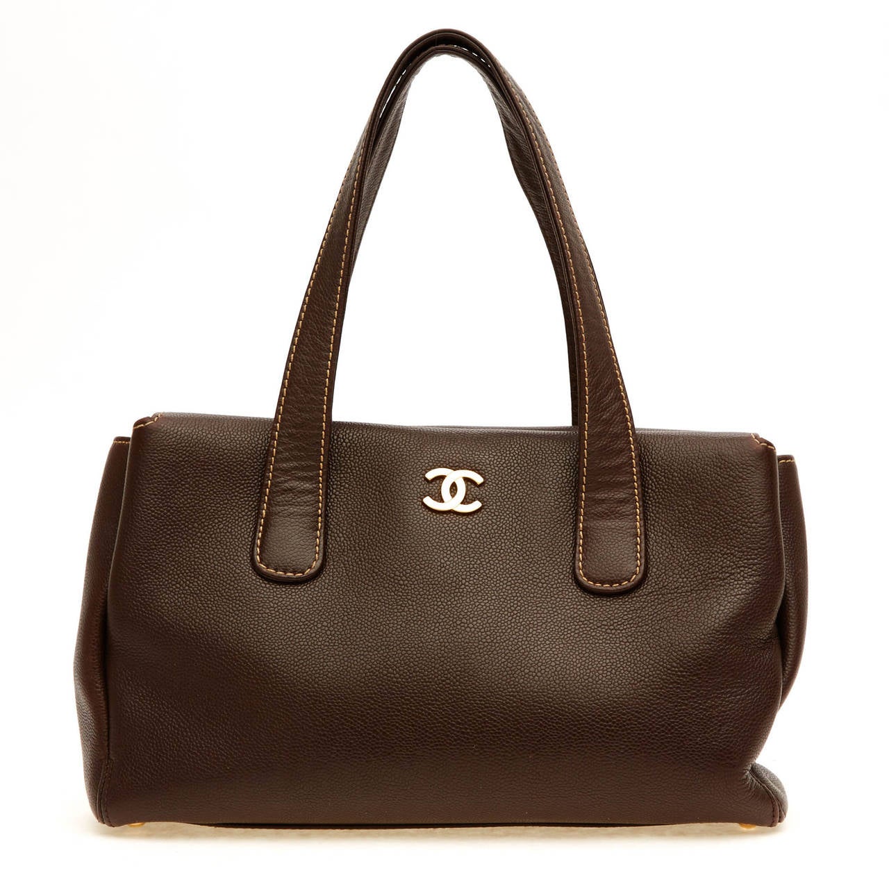 This beautifully understated Chanel Pebbled Leather Shoulder Bag is fit to be your essential everyday purse. It is constructed with soft pebbled chocolate brown leather and accented with gold tone hardware. It features the Chanel logo printed on the