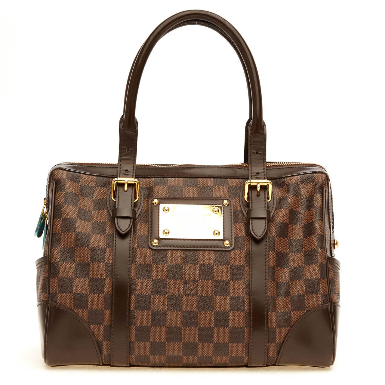 This alluring Louis Vuitton Damier Berkeley is constructed with signature Damier canvas. This is the ultimate luxurious purse you will not want to stop wearing. It is accented with leather trimmings, gold hardware, and red alcantara fabric lining.