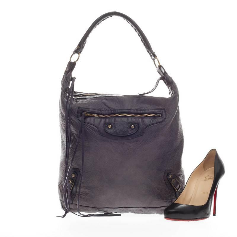 This authentic Balenciaga Day Hobo Classic Studs Leather is a go-to accessory that fits everyday essentials. Crafted in slate gray leather with a purple undertone, this spacious hobo is accented with an intertwined braided leather top handle, long