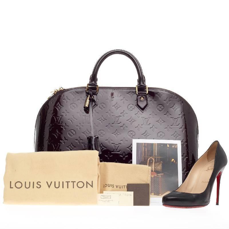 This authentic Louis Vuitton Alma Monogram Vernis GM is a fresh and elegant spin on a classic style that is perfect for all seasons. Crafted from Louis Vuitton's glossy vernis patent leather in beautiful amarante dark purple, this dome-shaped