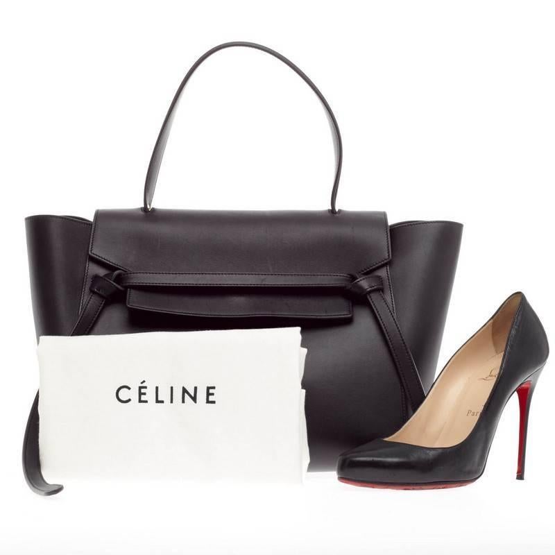 This authentic Celine Belt Bag Calfskin Medium is sure to make a statement. Crafted from navy blue calfskin leather, the bold and beautiful bag features expanded wings, looped single top handle, top flap slide closure, zipper pocket at the back for