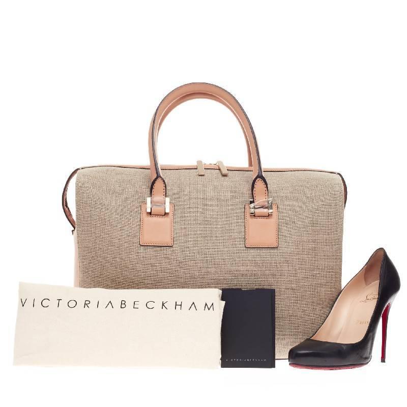 This authentic Victoria Beckham East West Victoria Tote Leather and Canvas eponymously named personifies the designer's clean and classic aesthetic. Crafted in lightweight neutral canvas with pale pink leather side and base panels and trim, this