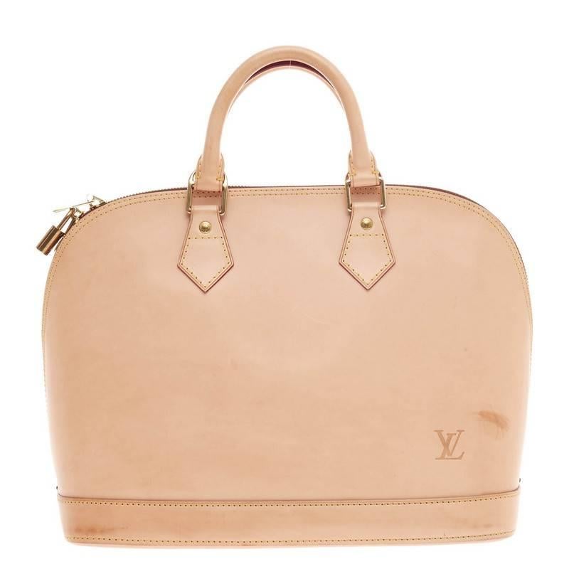 This authentic Louis Vuitton Alma Limited Edition Vachetta Leather PM is a unique piece specially made in commemoration of the brand's anniversary. Crafted in nomade vachetta leather, this limited edition Alma features dual-rolled handles, LV