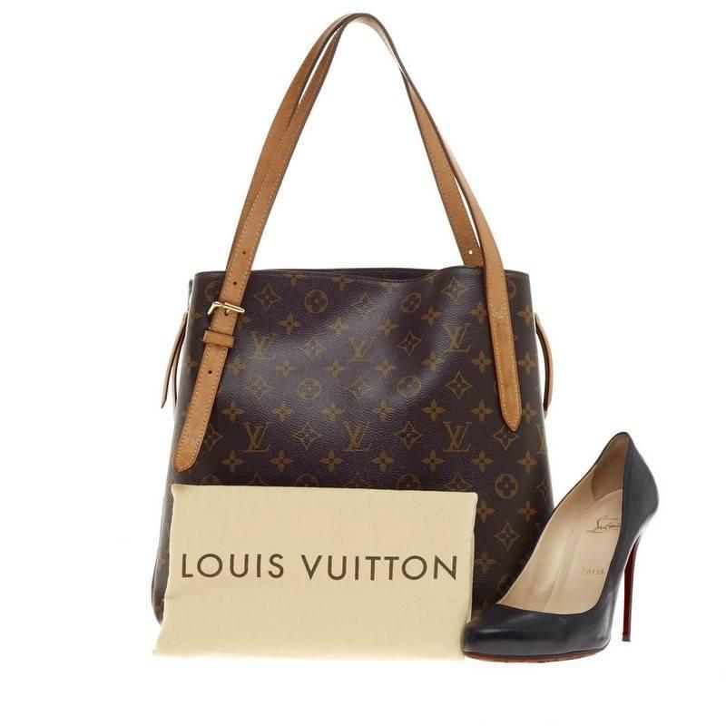 This authentic Louis Vuitton Voltaire Monogram Canvas is elegant and ideal for everyday use. Crafted in brown monogram canvas, this chic, versatile tote features dual vachetta leather slim straps, protective base studs, side zippers which expands