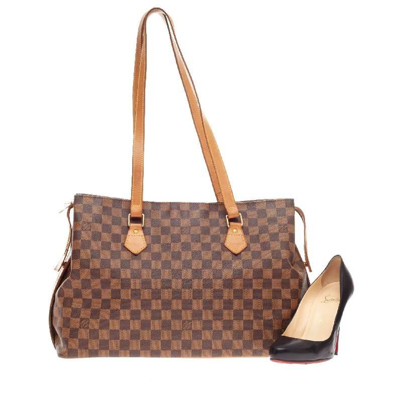 This authentic limited edition Louis Vuitton Chelsea Tote Centenaire Damier celebrates the 100th anniversary of the damier canvas line starting in 1896. This special edition tote constructed with classic Damier Ebene print canvas uniquely features