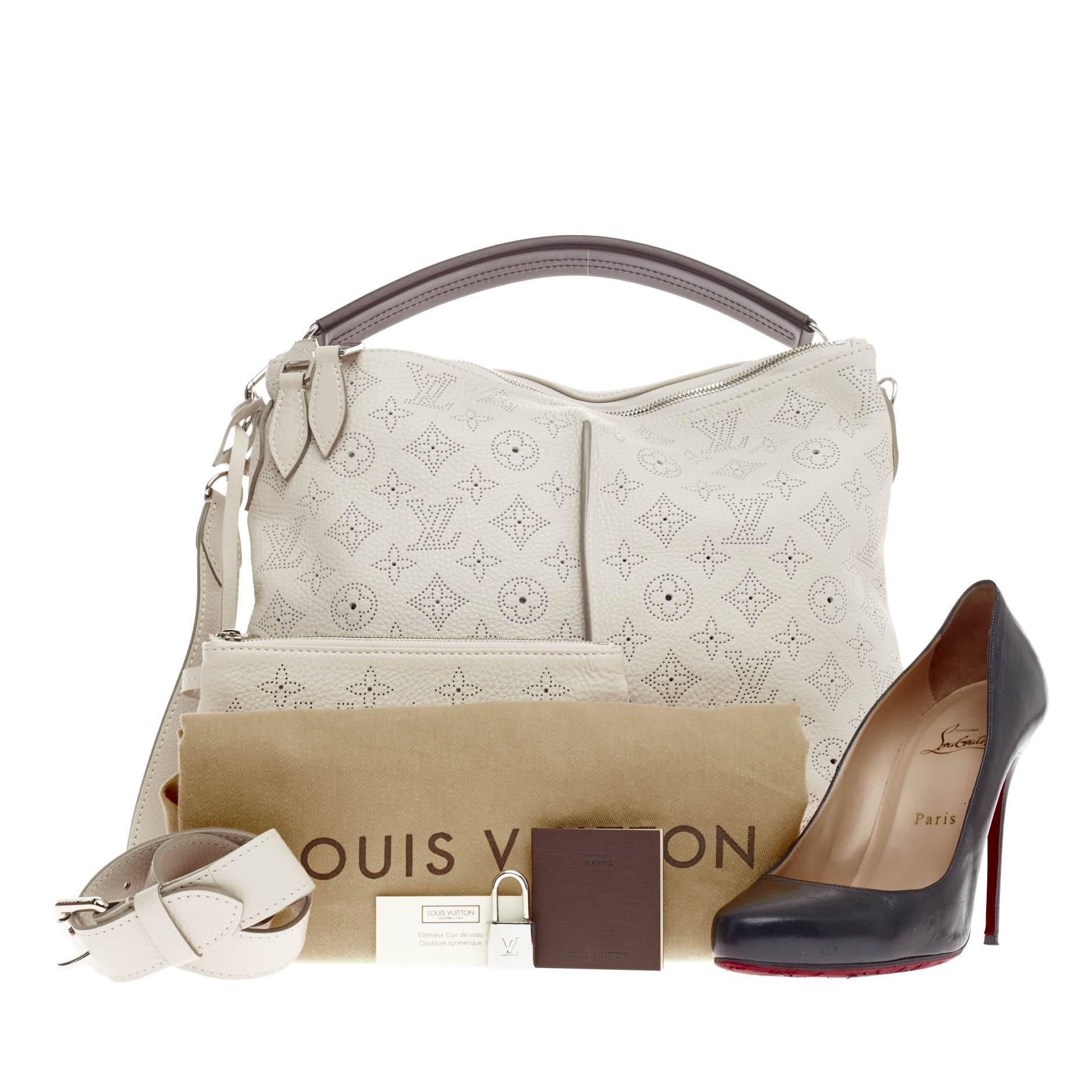 This authentic Louis Vuitton Selene Mahina Perforated Leather PM is an easy, feminine design constructed with intricate perforated LV monogram in beautiful, airy off-white mahina leather. Showcased in the brand's Spring/ Summer 2013 Collection, this