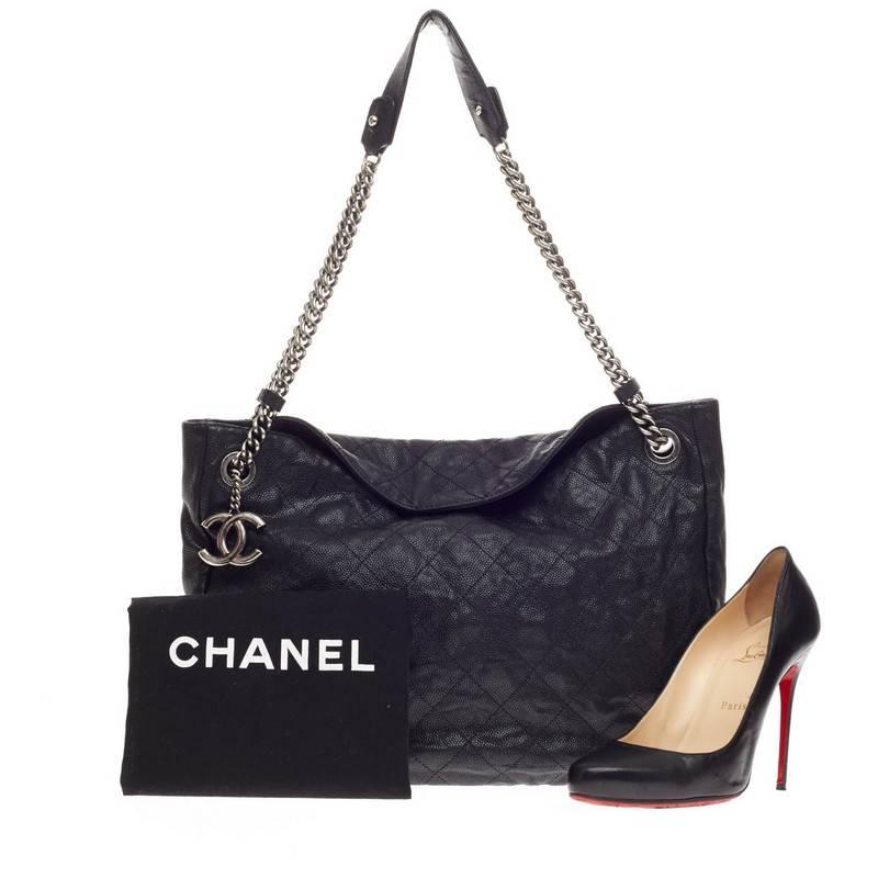 This authentic Chanel Simply CC Hobo Quilted Caviar from the brand's 2012 Collection is a simple  yet luxurious accessory, ideal for everyday use. Crafted in black quilted caviar leather, this chic hobo features signature ruthenium chain strap with