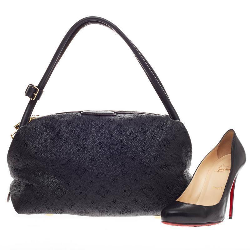 This authentic Louis Vuitton Galatea Mahina Leather PM released in the brand's 2011 Collection is a classic and feminine design meant to be adored like its namesake. Constructed in intricate perforated monogram in classic black mahina leather, this