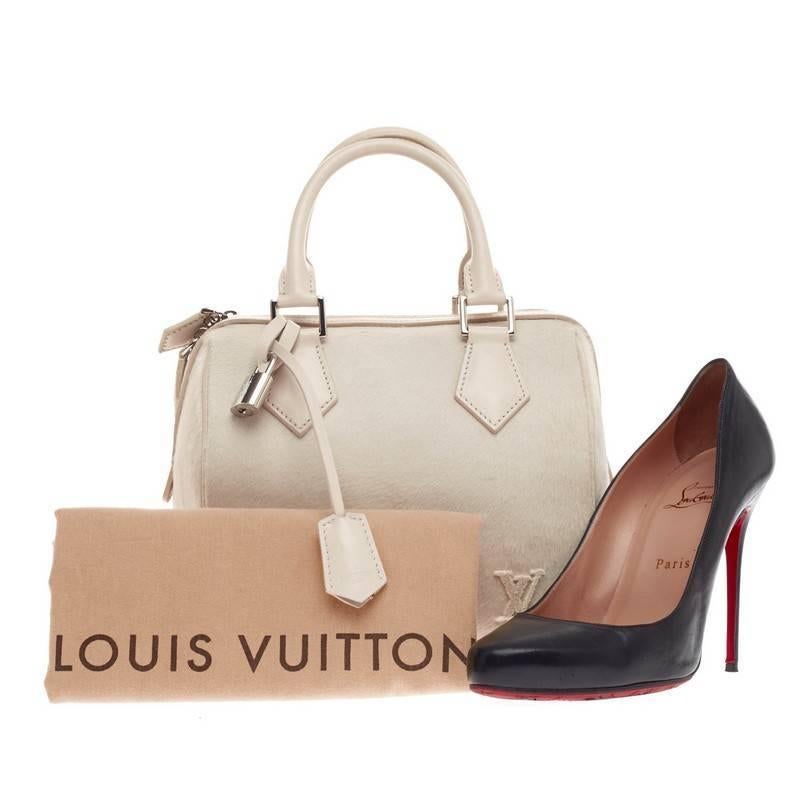 This authentic Louis Vuitton Speedy Cube Pony Hair PM presented during the brand's Spring/Summer 2013 Collection is a limited edition release to the classic speedy cube design. Crafted in plush ivory pony hair, this structured yet luxurious tote