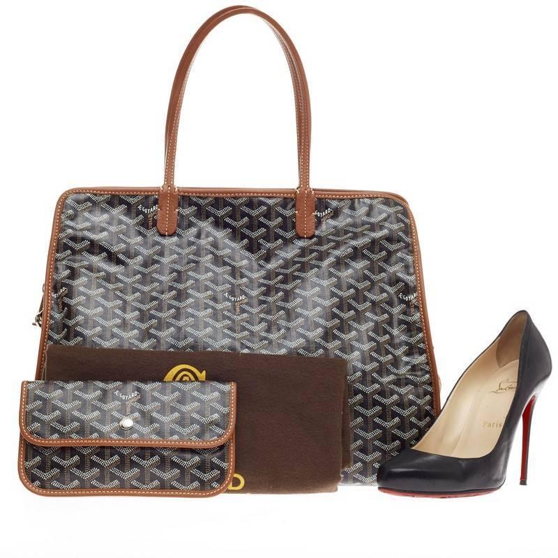 This authentic Goyard Hardy Pet Carrier Canvas PM is the perfect stylish travel companion for your little one. Constructed in classic black Goyard chevron canvas print with brown leather trimmings, this spacious dog carrier is equipped with dual-top