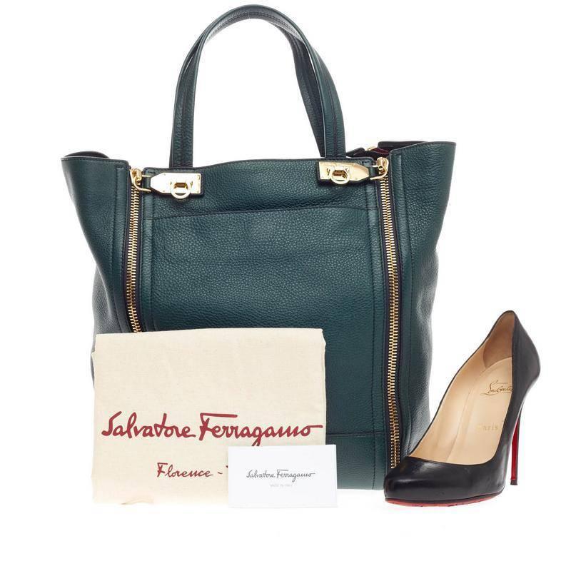 This authentic Salvatore Ferragamo Suzanne Tote Pebbled Leather mixes classic, easy-casual design with a fresh twist. Crafted in rich blue green pebbled leather, this tote features dual flat handles, front snap pocket, protective feet, exterior side