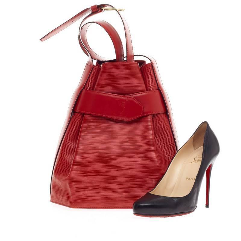 This authentic Louis Vuitton Vintage Sac d'Epaule Epi Leather PM is perfect for a casual chic look. Crafted in sturdy rouge red epi leather, this bag features brass-tone hardware accents and a reinforced base that allows the bag to be kept