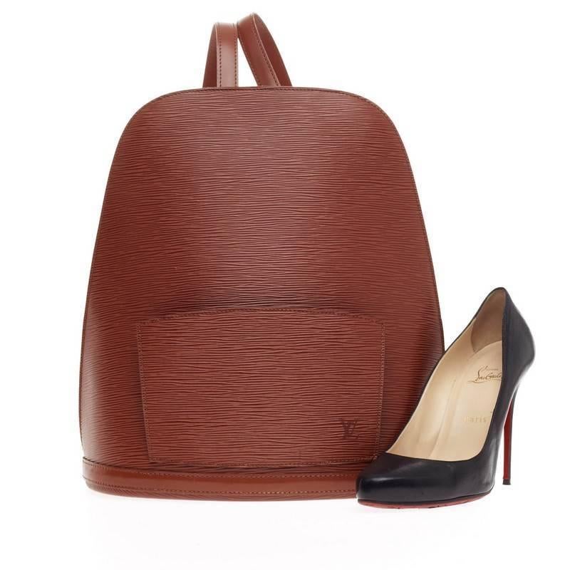 This authentic Louis Vuitton Gobelins Backpack Epi Leather is a stylish and practical bag for work or casual excursions. Crafted from Louis Vuitton's signature epi leather in kenyan fawn brown, this structured backpack features brass hardware,