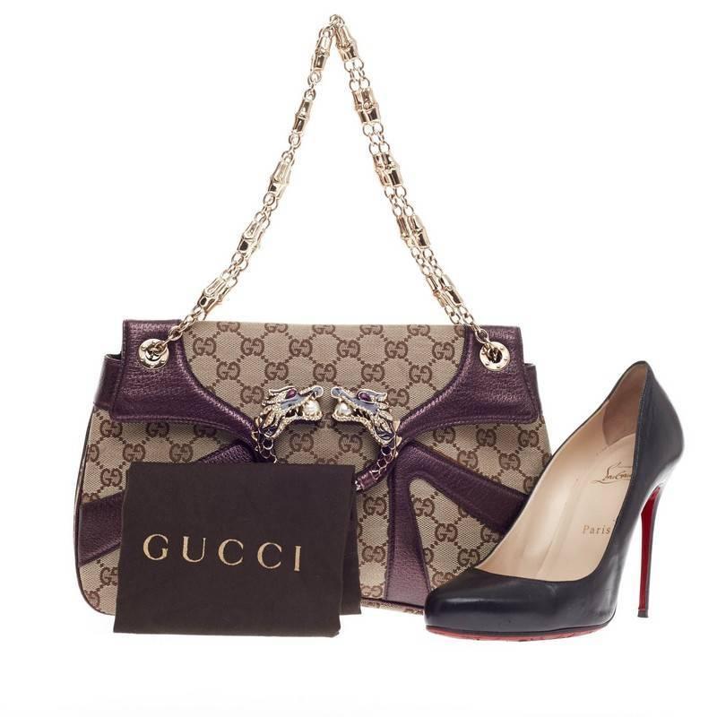 This authentic Gucci Jeweled Dragon Bag GG Canvas with Leather Trim created by Tom Ford for Gucci is a definite must-have for any stylish woman. Crafted from brown GG monogram canvas with purple leather trimmings, this iconic bag features a web