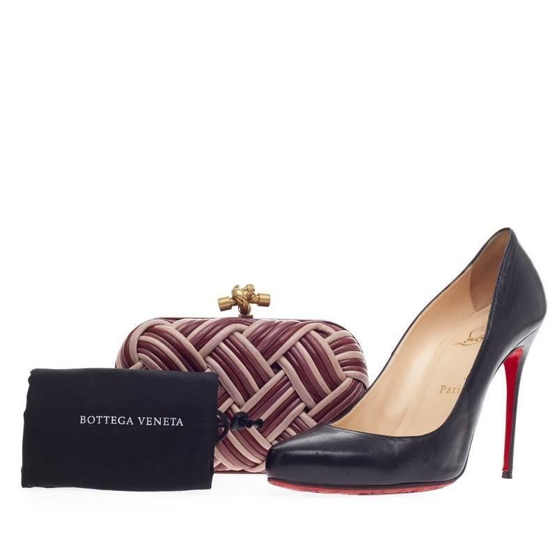 This authentic Bottega Veneta Box Knot Clutch Plaited Leather Small is a simple yet stunning accessory for any formal event. Crafted from multi-colored red and pink woven plaited leather, this sleek yet feminine clutch features red leather framing
