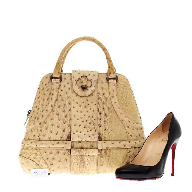 This authentic Alexander McQueen Novak Satchel Ostrich in beautiful pale yellow showcases the brand's luxurious feminine style and dedication to high craftsmanship. A perfect accessory for spring, this structured dome bag features genuine ostrich