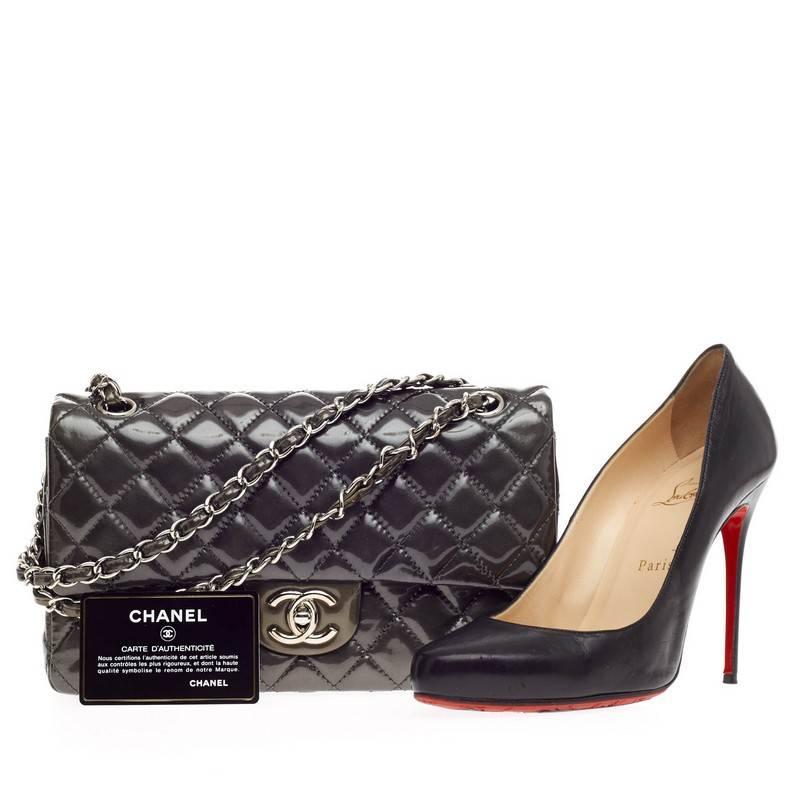 This authentic Chanel Classic Double Flap Quilted Patent Medium exudes a classic yet easy style made for the modern woman. Crafted in metallic olive green with Chanel's signature diamond quilting design, this elegant flap features woven-in leather