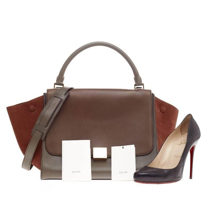 This authentic Celine Trapeze Tricolor Leather and Suede Medium is a modern classic, featuring a fall-ready palette of brown and gray leather body with burgundy suede wings. With its subdued color palette, gold hardware and minimalist design, this