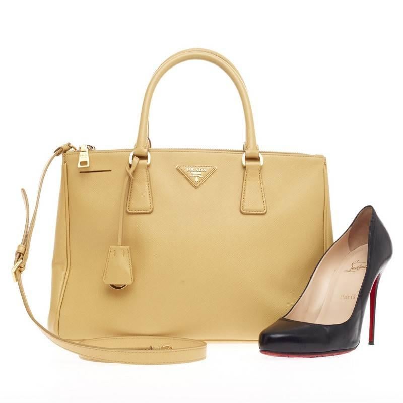 This authentic Prada Double Zip Lux Tote Saffiano Leather Medium is the perfect bag to complete any summer outfit. Crafted in pale yellow saffiano leather, this elegant and chic statement piece can be handheld or worn on the shoulder with its